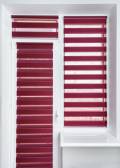 Red or magenta fabric roller blinds on the plastic window and balcony door. Window roller, duo system day and night