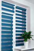 Windows with closed modern horizontal blinds indoors closeup. Window roller, duo system day and night. Beautiful blue color blinds on the window